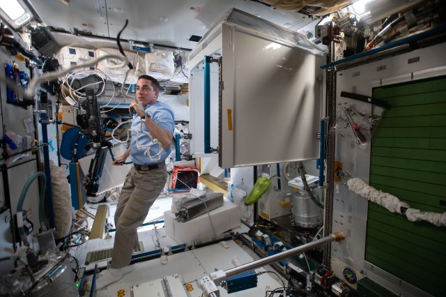 NASA astronaut and Expedition 63 Commander Chris Cassidy calls down to Mission Control and gets ready for high-flying, orbital plumbing work inside the Waste and Hygiene Compartment, the International Space Station's bathroom located inside the Tranquility module.