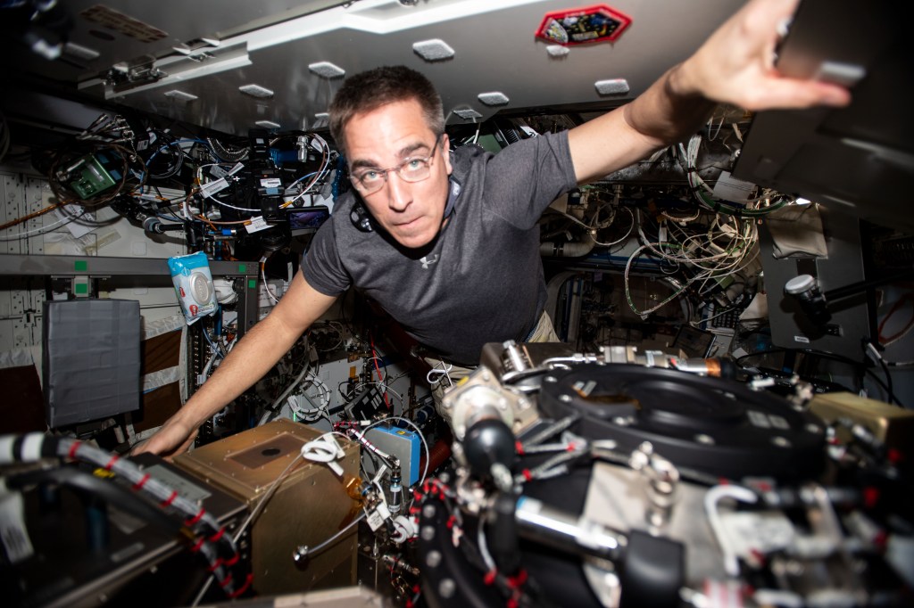 NASA astronaut and Expedition 63 Commander Chris Cassidy performs maintenance on the Combustion Integrated Rack, a research device that enables safe fuel, flame and soot studies in microgravity.