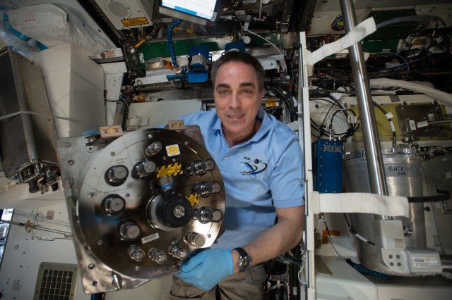 NASA astronaut and Expedition 63 Commander Chris Cassidy replaces components inside the Waste and Hygiene Compartment, the International Space Station's bathroom located inside the Tranquility module.
