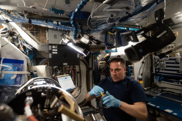NASA astronaut and Expedition 63 Commander Chris Cassidy replaces components inside the Combustion Integrated Rack to support a series of ongoing flame and fuel studies known as Advanced Combustion via Microgravity Experiments (ACME).