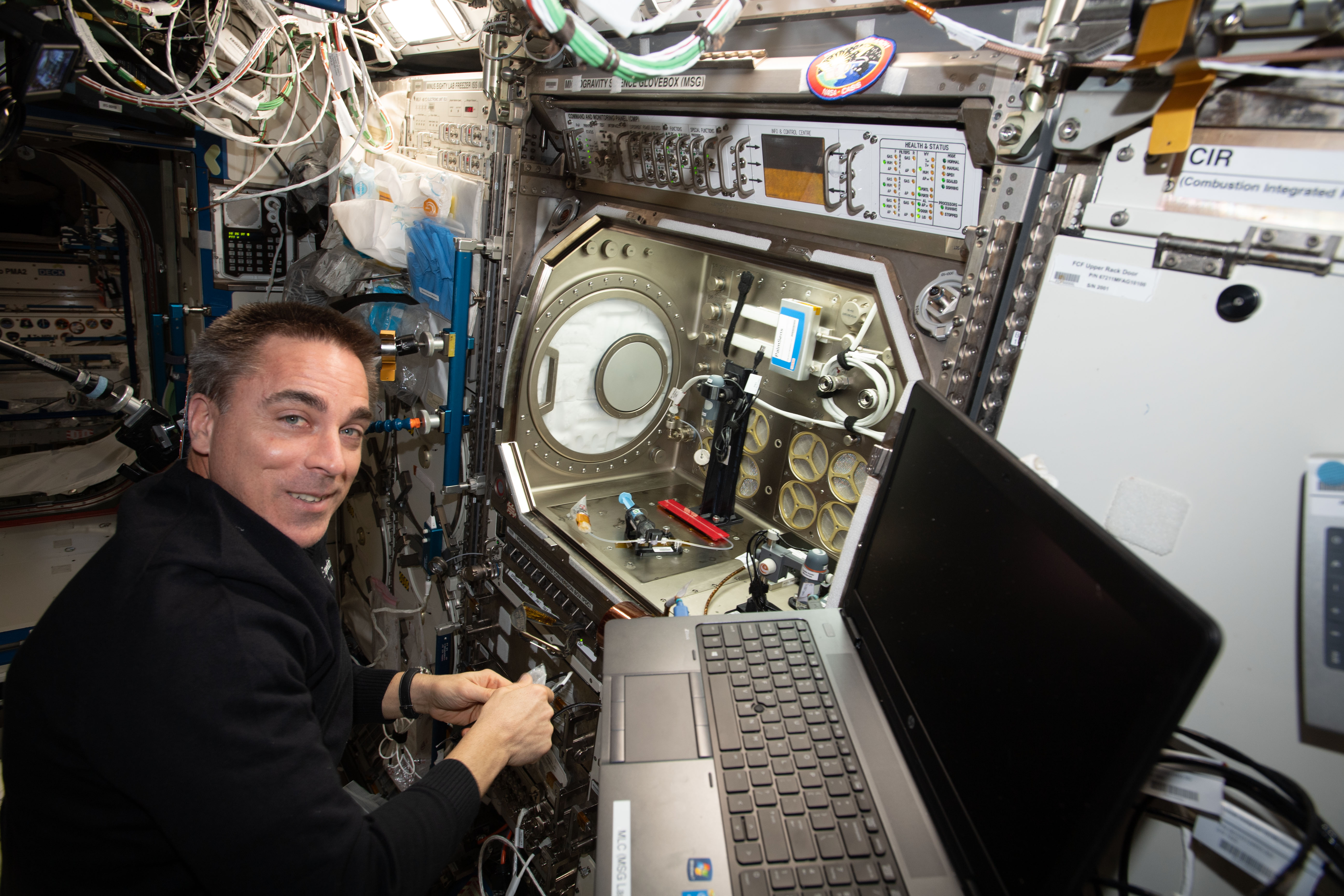 NASA astronaut and Expedition 63 Commander Chris Cassidy sets up the Microgravity Science Glovebox for a space bubbles experiment. The Electrolysis Measurement study is observing how bubbles inside microfluid systems may help produce oxygen on a spacecraft and deliver drugs though skin patches.