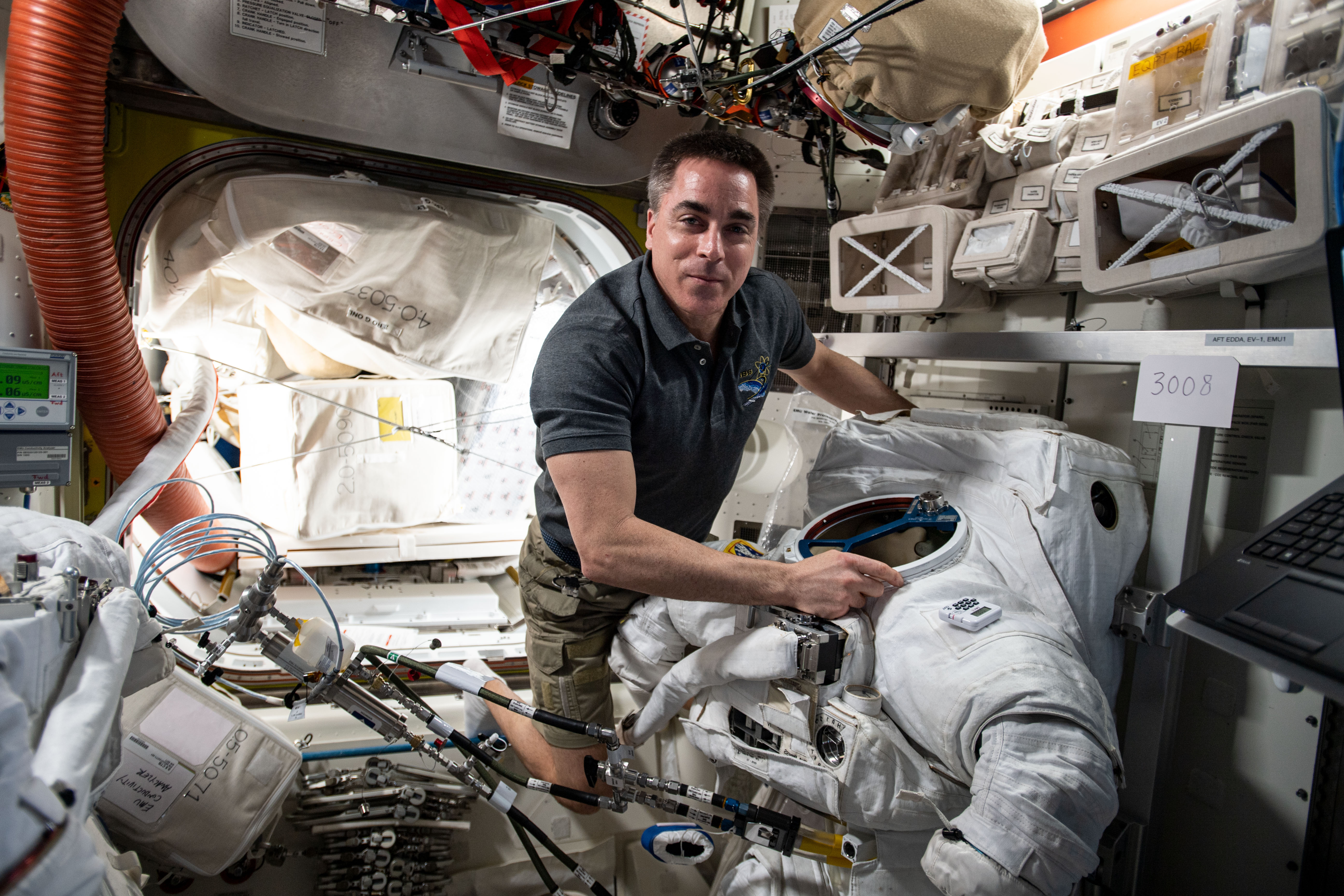 NASA astronaut and Expedition 63 Commander Chris Cassidy works on a U.S. spacesuit inside the Quest airlock of the International Space Station.