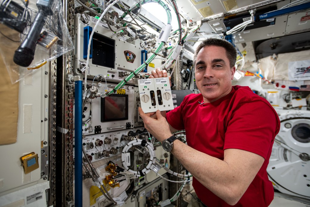 NASA astronaut and Expedition 63 Commander Chris Cassidy works on research hardware inside the JAXA (Japan Aerospace Exploration Agency) Kibo laboratory module.