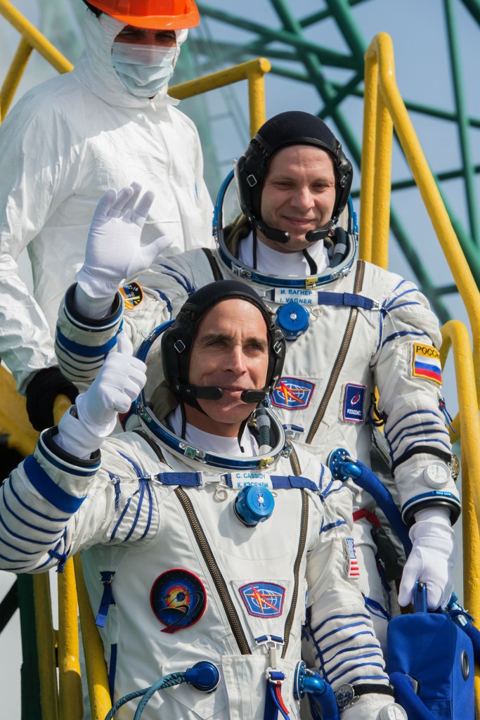 Expedition 63 Crew Waves Farewell - Expedition 63 crewmembers Ivan Vagner of Roscosmos, top, and Chris Cassidy of NASA wave goodbye as they and Anatoly Ivanishin of Roscosmos prepare to climb aboard the Soyuz MS-16 rocket at Site 31 at the Baikonur Cosmodrome in Kazakhstan, Thursday, April 9, 2020. They launched a short time later to the International Space Station for the start of a six-and-a-half month mission.
