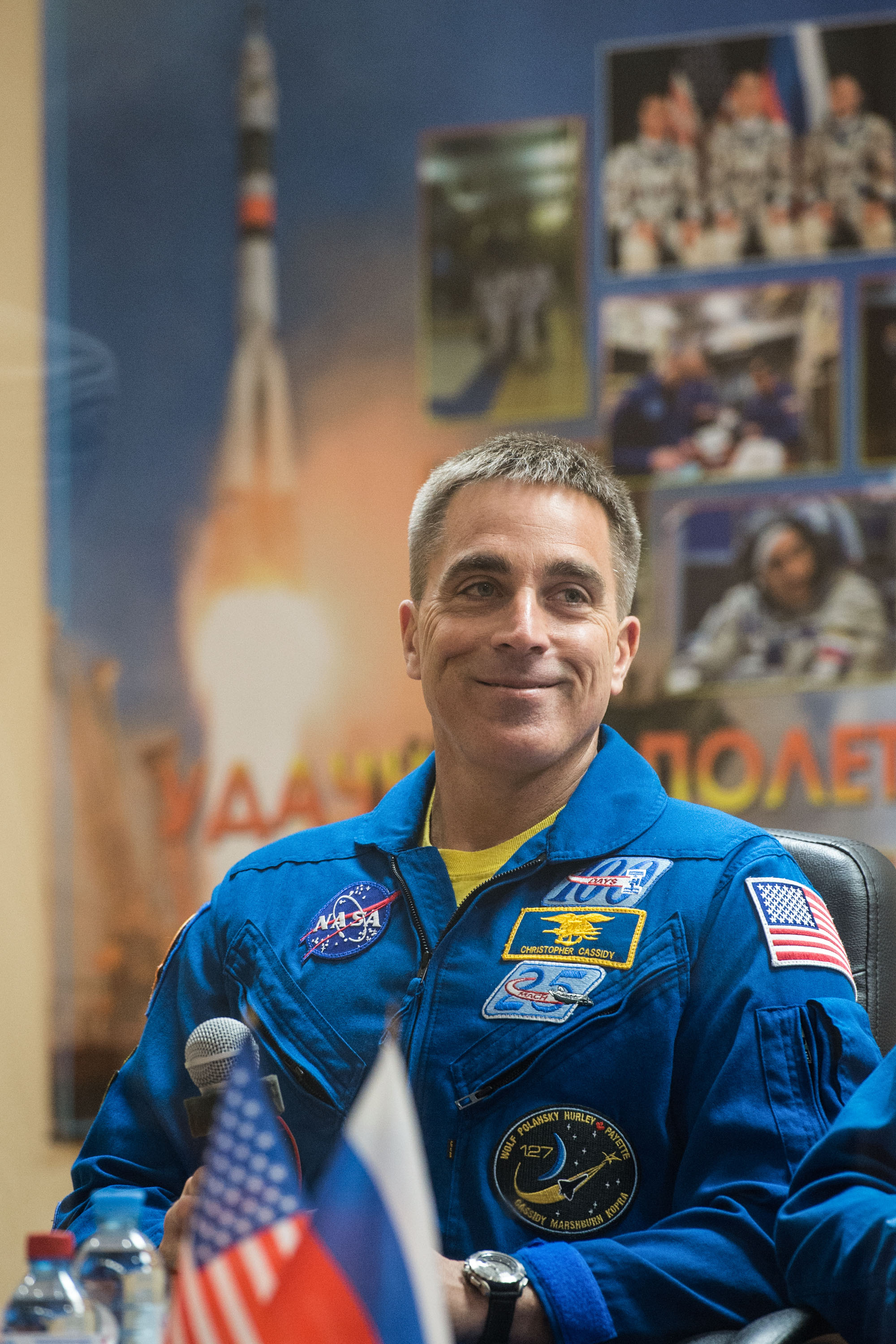 jsc2020e017040 (April 8, 2020) --- At the Cosmonaut Hotel crew quarters in Baikonur, Kazakhstan, Expedition 63 crewmember Chris Cassidy of NASA smiles as he responds to questions provided by reporters in a virtual question and answer session April 8 as he prepares for launch. Cassidy and Anatoly Ivanishin and Ivan Vagner of Roscosmos will launch April 9 on the Soyuz MS-16 spacecraft from the Baikonur Cosmodrome for a six-and-a-half month mission on the International Space Station.