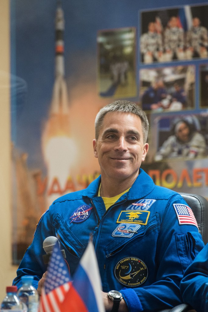 jsc2020e017040 (April 8, 2020) --- At the Cosmonaut Hotel crew quarters in Baikonur, Kazakhstan, Expedition 63 crewmember Chris Cassidy of NASA smiles as he responds to questions provided by reporters in a virtual question and answer session April 8 as he prepares for launch. Cassidy and Anatoly Ivanishin and Ivan Vagner of Roscosmos will launch April 9 on the Soyuz MS-16 spacecraft from the Baikonur Cosmodrome for a six-and-a-half month mission on the International Space Station.