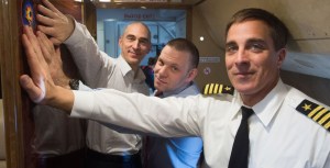 Aboard a Gagarin Cosmonaut Training Center aircraft, Expedition 63 crewmembers Anatoly Ivanishin (left) and Ivan Vagner (center) of Roscosmos and Chris Cassidy (right) of NASA affix a decal of their mission insignia on the wall of their plane March 24 as they flew to their launch site at the Baikonur Cosmodrome in Kazakhstan. They will launch April 9 on the Soyuz MS-16 spacecraft from Baikonur for a six-and-a-half month mission on the International Space Station.