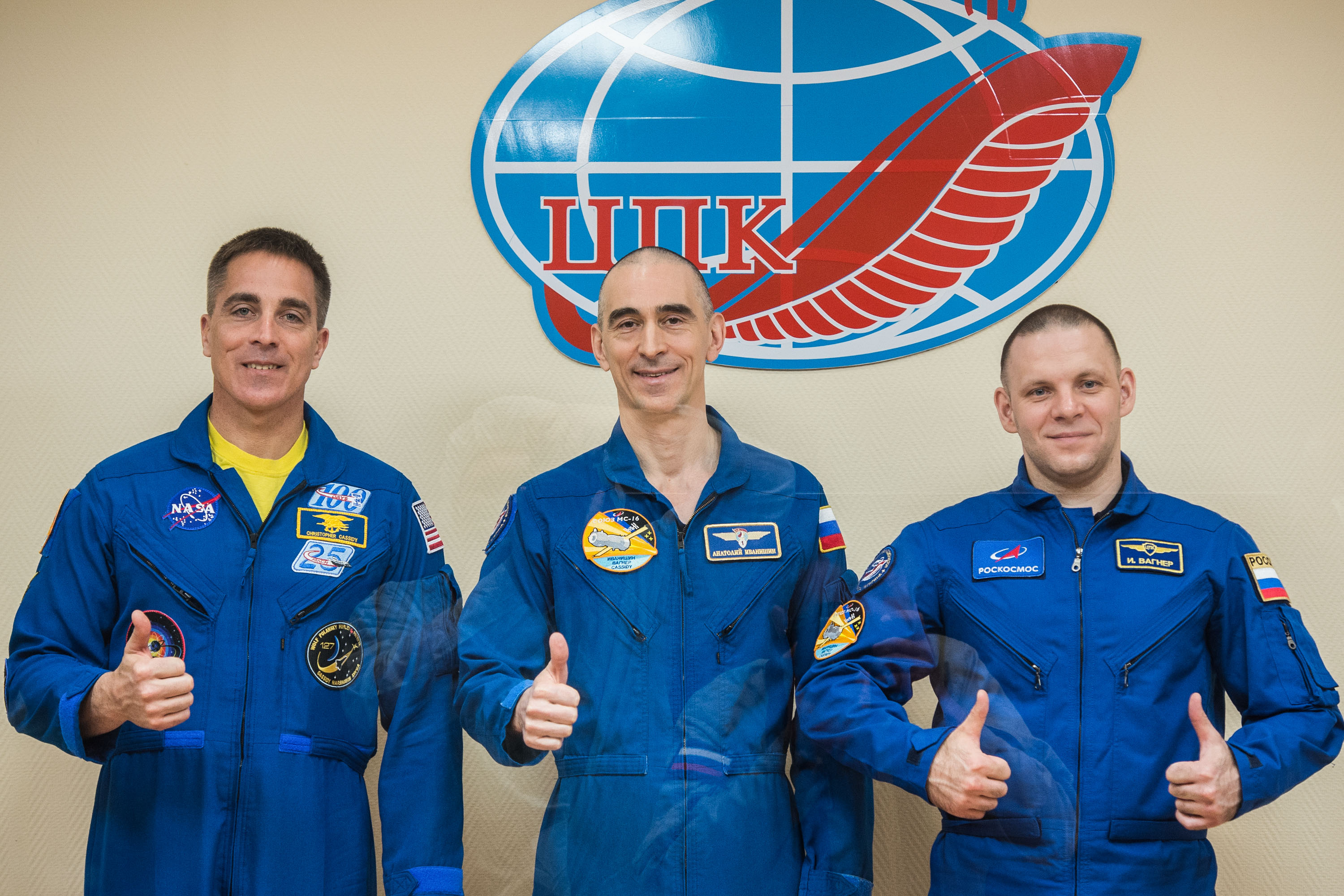 At the Cosmonaut Hotel crew quarters in Baikonur, Kazakhstan, Expedition 63 crewmembers Chris Cassidy of NASA (left) and Anatoly Ivanishin (center) and Ivan Vagner (right) of Roscosmos pose for pictures April 8 as they prepare for launch. They will launch April 9 on the Soyuz MS-16 spacecraft from the Baikonur Cosmodrome for a six-and-a-half month mission on the International Space Station.