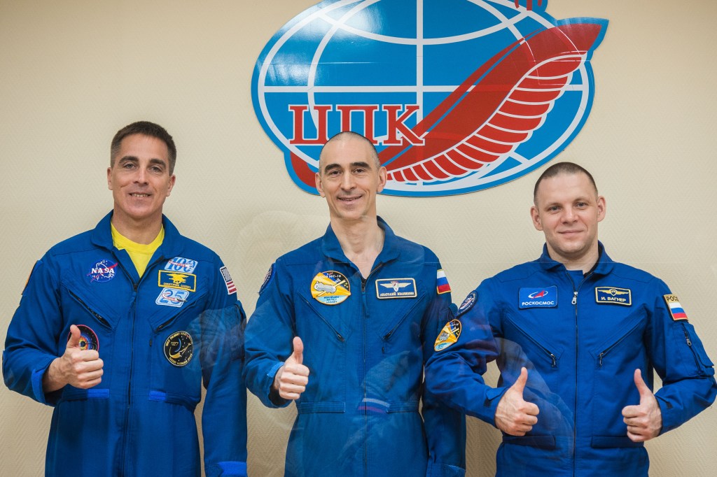At the Cosmonaut Hotel crew quarters in Baikonur, Kazakhstan, Expedition 63 crewmembers Chris Cassidy of NASA (left) and Anatoly Ivanishin (center) and Ivan Vagner (right) of Roscosmos pose for pictures April 8 as they prepare for launch. They will launch April 9 on the Soyuz MS-16 spacecraft from the Baikonur Cosmodrome for a six-and-a-half month mission on the International Space Station.
