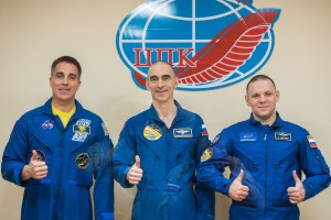 At the Cosmonaut Hotel crew quarters in Baikonur, Kazakhstan, Expedition 63 crewmembers Chris Cassidy of NASA (left) and Anatoly Ivanishin (center) and Ivan Vagner (right) of Roscosmos pose for pictures April 8 as they prepare for launch. They will launch April 9 on the Soyuz MS-16 spacecraft from the Baikonur Cosmodrome for a six-and-a-half month mission on the International Space Station.