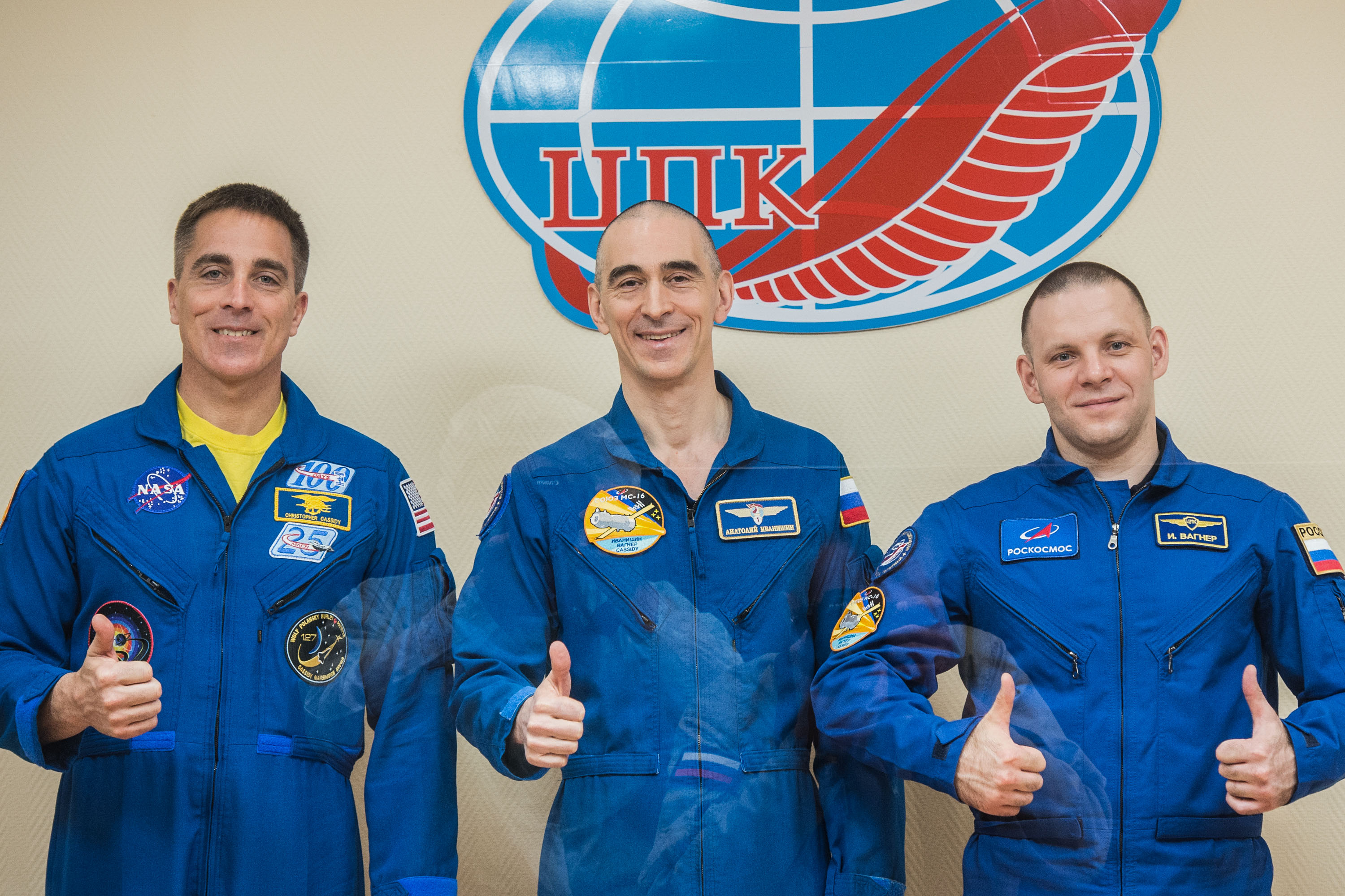 At the Cosmonaut Hotel crew quarters in Baikonur, Kazakhstan, Expedition 63 crewmembers Chris Cassidy of NASA (left) and Anatoly Ivanishin (center) and Ivan Vagner (right) of Roscosmos pose for pictures April 8 as they prepare for launch. They will launch April 9 on the Soyuz MS-16 spacecraft from the Baikonur Cosmodrome for a six-and-a-half month mission on the International Space Station.