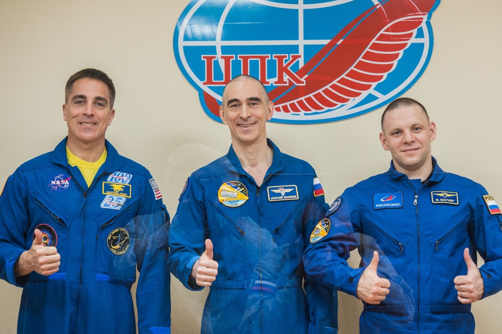 At the Cosmonaut Hotel crew quarters in Baikonur, Kazakhstan, Expedition 63 crewmembers Chris Cassidy of NASA (left) and Anatoly Ivanishin (center) and Ivan Vagner (right) of Roscosmos pose for pictures April 8 as they prepare for launch. They will launch April 9 on the Soyuz MS-16 spacecraft from the Baikonur Cosmodrome for a six-and-a-half month mission on the International Space Station.