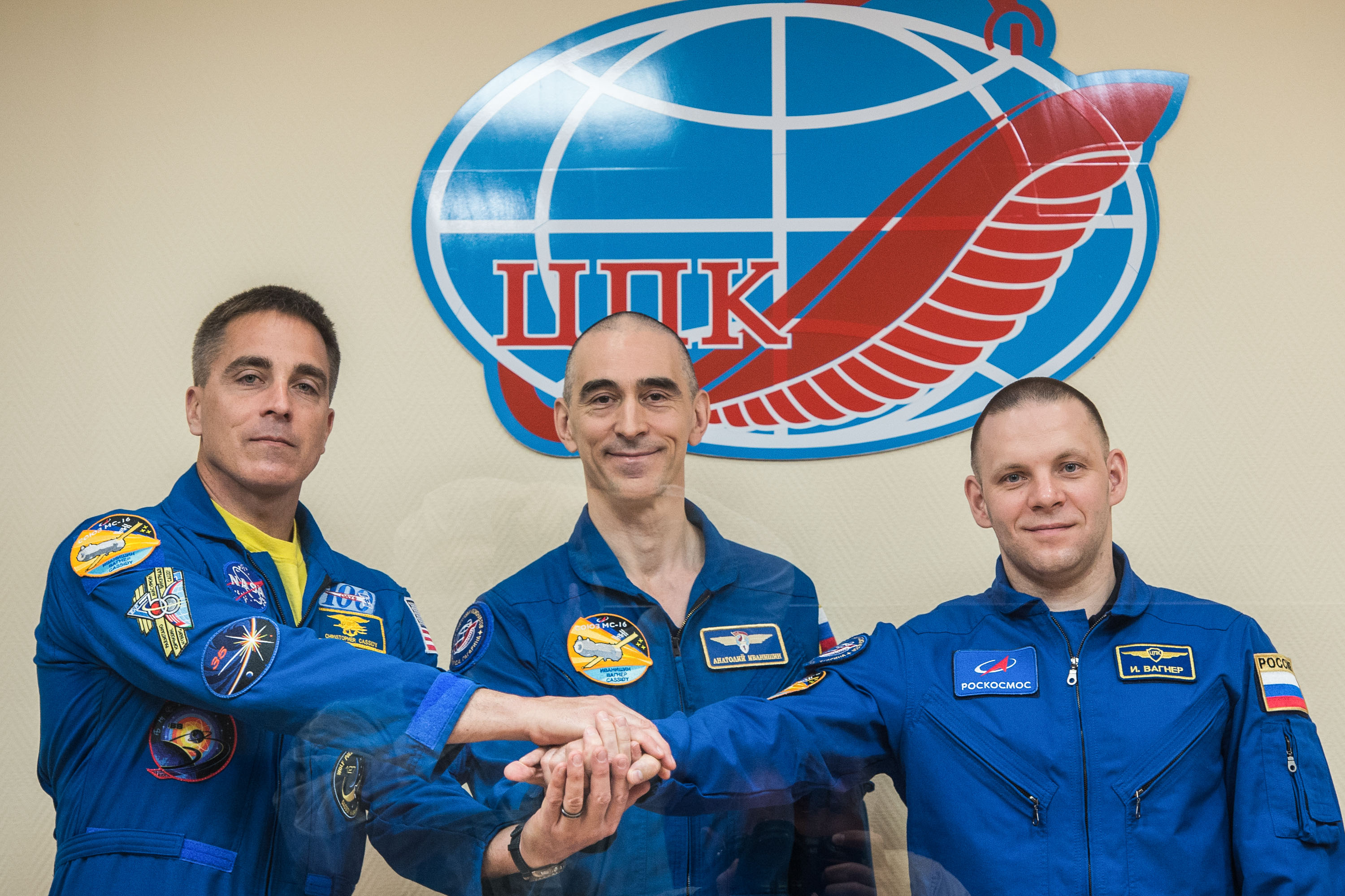 At the Cosmonaut Hotel crew quarters in Baikonur, Kazakhstan, Expedition 63 crewmembers Chris Cassidy of NASA (left) and Anatoly Ivanishin (center) and Ivan Vagner (right) of Roscosmos pose for pictures April 8 as they prepare for launch. They will launch April 9 on the Soyuz MS-16 spacecraft from the Baikonur Cosmodrome for a six-and-a-half month mission on the International Space Station.
