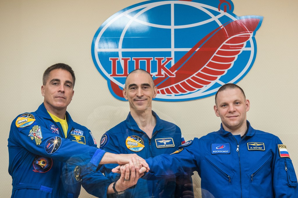 At the Cosmonaut Hotel crew quarters in Baikonur, Kazakhstan, Expedition 63 crewmembers Chris Cassidy of NASA (left) and Anatoly Ivanishin (center) and Ivan Vagner (right) of Roscosmos pose for pictures April 8 as they prepare for launch. They will launch April 9 on the Soyuz MS-16 spacecraft from the Baikonur Cosmodrome for a six-and-a-half month mission on the International Space Station.