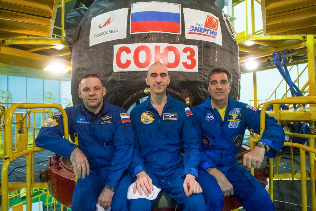 At the Baikonur Cosmodrome in Kazakhstan, Expedition 63 crewmembers Ivan Vagner (left) and Anatoly Ivanishin (center) of Roscosmos and Chris Cassidy of NASA (right) pose for pictures March 25 in front of their Soyuz MS-16 spacecraft as part of pre-launch training activities. They will launch April 9 on the Soyuz from Baikonur for a six-and-a-half month mission on the International Space Station.