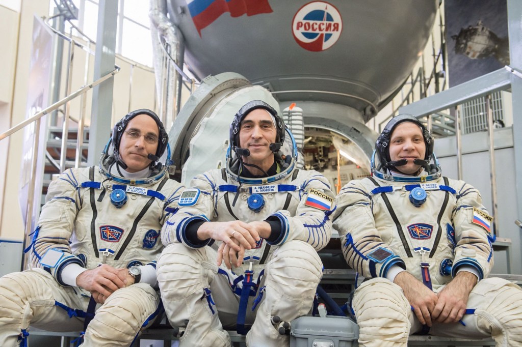 At the Gagarin Cosmonaut Training Center in Star City, Russia, Expedition 63 crewmembers Chris Cassidy of NASA (left) and Anatoly Ivanishin (center) and Ivan Vagner of Roscosmos (right) pose for pictures in front of a Soyuz trainer during the second day of Soyuz qualification exams March 12. They are scheduled to launch April 9 on the Soyuz MS-16 spacecraft from the Baikonur Cosmodrome in Kazakhstan for a six-and-a-half month mission on the International Space Station.