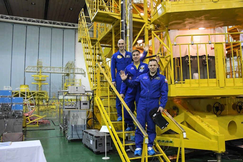 At the Baikonur Cosmodrome in Kazakhstan, Expedition 63 crewmembers Anatoly Ivanishin (top) of Roscosmos, Chris Cassidy (center) of NASA and Ivan Vagner (bottom) of Roscosmos pose for pictures April 3 in front of their Soyuz spacecraft as part of their pre-launch activities. They will launch April 9 on the Soyuz MS-16 spacecraft from Baikonur on April 9 for a six-and-a-half month mission on the International Space Station.
