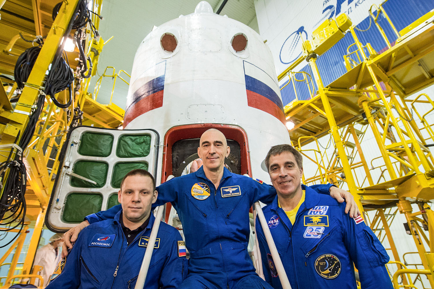 At the Baikonur Cosmodrome in Kazakhstan, Expedition 63 crewmembers Ivan Vagner (left) and Anatoly Ivanishin (center) of Roscosmos and Chris Cassidy (right) of NASA pose for pictures April 3 in front of their Soyuz spacecraft as part of their pre-launch activities. They will launch April 9 on the Soyuz MS-16 spacecraft from Baikonur on April 9 for a six-and-a-half-month mission on the International Space Station.