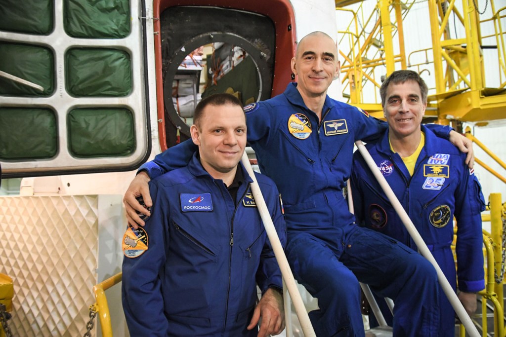 At the Baikonur Cosmodrome in Kazakhstan, Expedition 63 crewmembers Ivan Vagner (left) and Anatoly Ivanishin (center) of Roscosmos and Chris Cassidy (right) of NASA pose for pictures April 3 in front of their Soyuz spacecraft as part of their pre-launch activities. They will launch April 9 on the Soyuz MS-16 spacecraft from Baikonur on April 9 for a six-and-a-half month mission on the International Space Station.