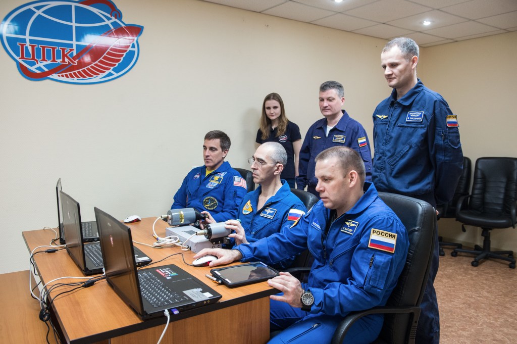 At the Cosmonaut Hotel crew quarters in Baikonur, Kazakhstan, Expedition 63 crewmembers Chris Cassidy of NASA (left) and Anatoly Ivanishin (center) and Ivan Vagner (right) of Roscosmos practice rendezvous techniques on a laptop simulator April 1 as they prepare for launch. They will launch April 9 on the Soyuz MS-16 spacecraft from the Baikonur Cosmodrome in Kazakhstan for a six-and-a-half month mission on the International Space Station.