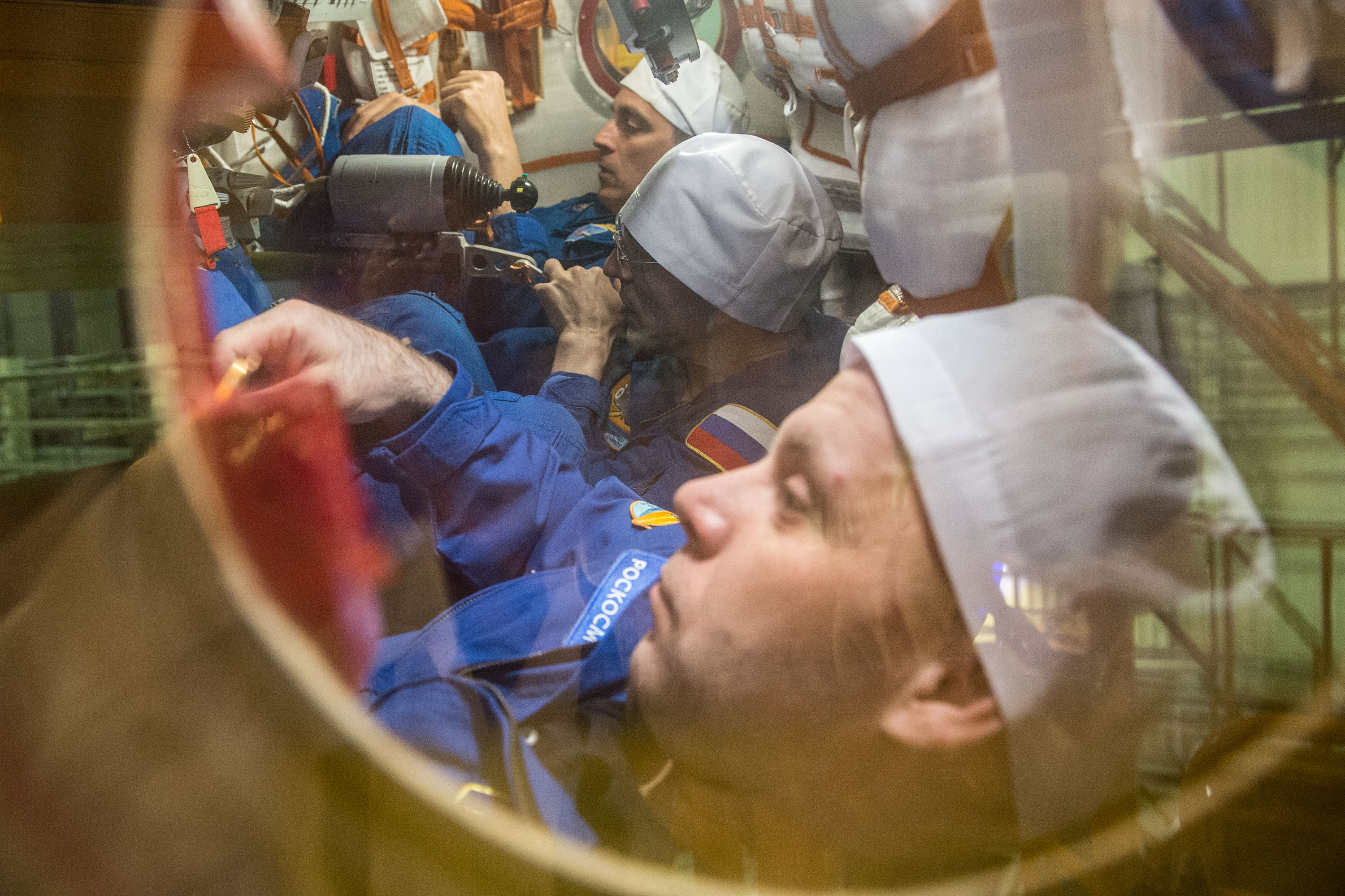 At the Baikonur Cosmodrome in Kazakhstan, Expedition 63 crewmembers Chris Cassidy of NASA (top) and Anatoly Ivanishin (center) and Ivan Vagner (bottom) of Roscosmos run through procedures during a pre-launch training session in the Soyuz MS-16 spacecraft March 25. They will launch April 9 on the Soyuz from Baikonur for a six-and-a-half month mission on the International Space Station.