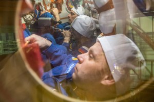 At the Baikonur Cosmodrome in Kazakhstan, Expedition 63 crewmembers Chris Cassidy of NASA (top) and Anatoly Ivanishin (center) and Ivan Vagner (bottom) of Roscosmos run through procedures during a pre-launch training session in the Soyuz MS-16 spacecraft March 25. They will launch April 9 on the Soyuz from Baikonur for a six-and-a-half month mission on the International Space Station.