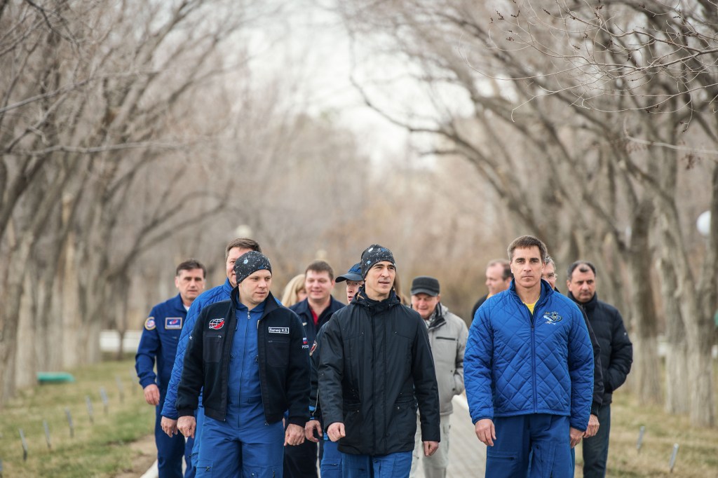 At the Cosmonaut Hotel crew quarters in Baikonur, Kazakhstan, Expedition 63 crewmembers Ivan Vagner (left) and Anatoly Ivanishin (center) of Roscosmos and Chris Cassidy of NASA (right) take a stroll down the Walk of Cosmonauts April 1. They will launch April 9 on the Soyuz MS-16 spacecraft from the Baikonur Cosmodrome in Kazakhstan for a six-and-a-half month mission on the International Space Station.