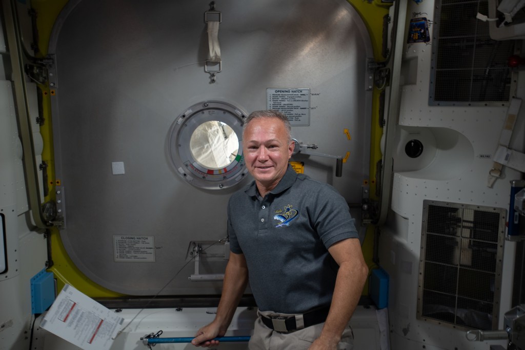 Expedition 63 Flight Engineer Doug Hurley of NASA is pictured in the Quest airlock after assisting NASA spacewalkers (out of frame) Bob Behnken and Chris Cassidy into the crew lock before their spacewalk on June 26.