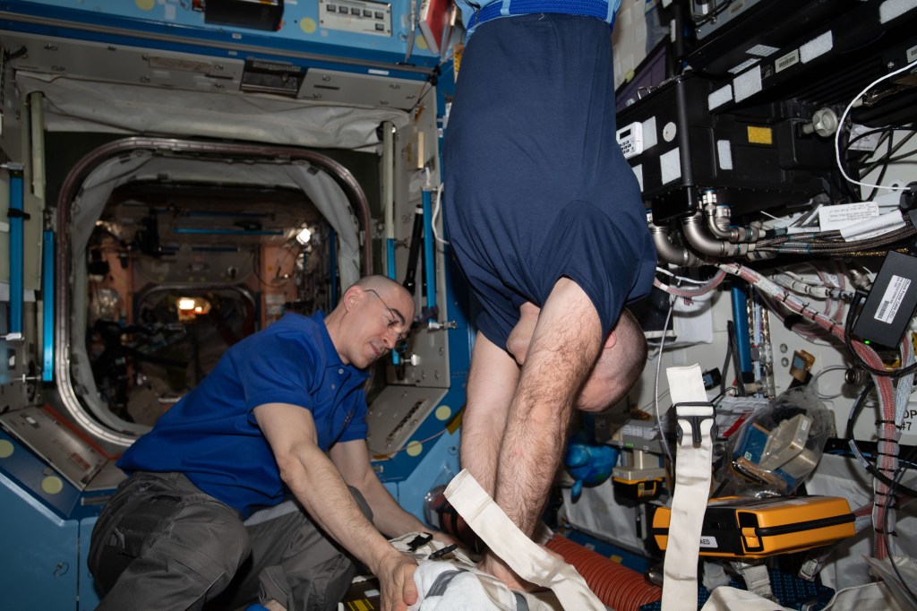 Roscosmos cosmonauts and Expedition 63 Flight Engineers (from left) Anatoly Ivanishin and Ivan Vagner practice chest compression techniques, or cardiopulmonary resuscitation (CPR), during an emergency training session. The crews aboard the International Space Station regularly train for a variety of emergency scenarios to stay familiar with medical hardware, safety gear and evacuation paths. Mission controllers on the ground also participate to maintain coordination and communication protocols.