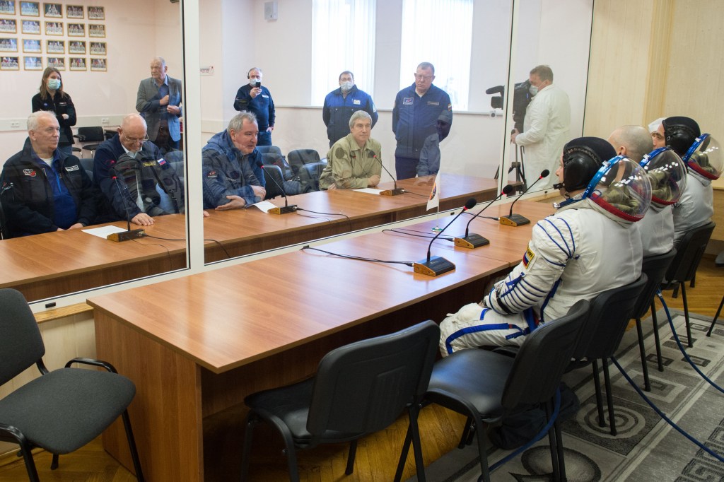 Expedition 63 crewmembers Chris Cassidy of NASA, Anatoly Ivanishin and Ivan Vagner of Roscosmos, talk to Roscosmos Director General Dmitry Rogozin, 3rd from left, and other mission managers prior to departing for the launch pad, Thursday, April 9, 2020 at the Baikonur Cosmodrome in Kazakhstan. A few hours later, they lifted off on a Soyuz rocket for a six-and-a-half month mission on the International Space Station.
