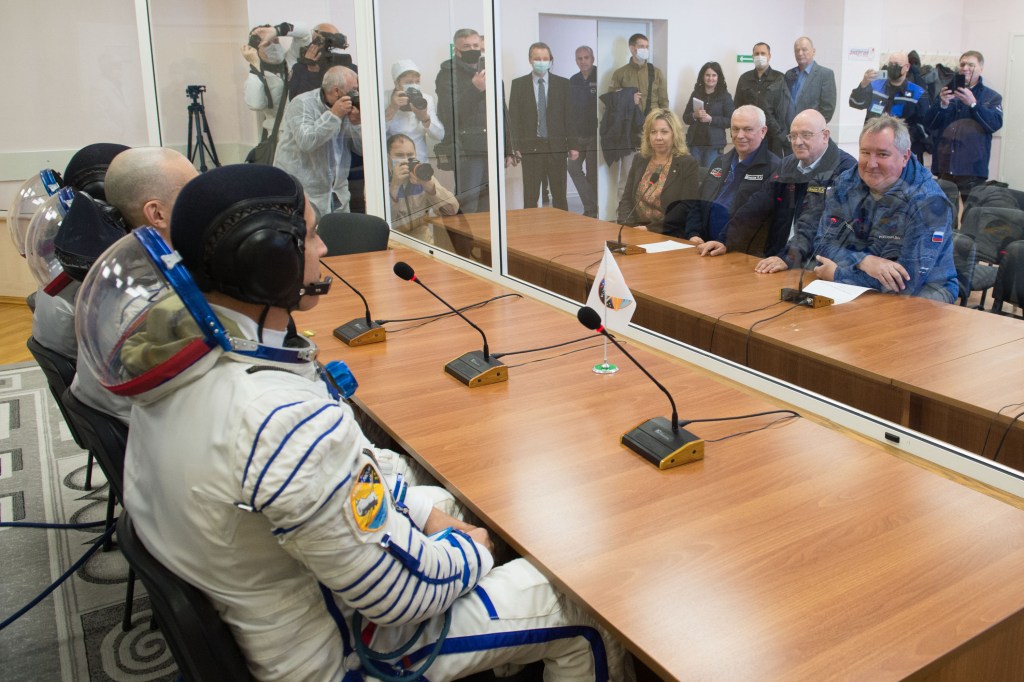 Expedition 63 crewmembers Chris Cassidy of NASA, Anatoly Ivanishin and Ivan Vagner of Roscosmos, talk to Roscosmos Director General Dmitry Rogozin, right, NASA Director for Human Space Flight Programs, Russia, Tricia Mack, left, and other mission managers prior to departing for the launch pad, Thursday, April 9, 2020 at the Baikonur Cosmodrome in Kazakhstan. A few hours later, they lifted off on a Soyuz rocket for a six-and-a-half month mission on the International Space Station.