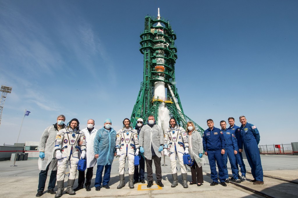 Expedition 63 crewmembers Ivan Vagner of Roscosmos, Anatoly Ivanishin of Roscosmos, and Chris Cassidy of NASA, pose for a group photograph with Roscosmos Director General Dmitry Rogozin, center, mission management and the backup the crew at the launch pad, Thursday, April 9, 2020 at the Baikonur Cosmodrome in Kazakhstan. A few hours later, the crew lifted off on a Soyuz rocket for a six-and-a-half month mission on the International Space Station.