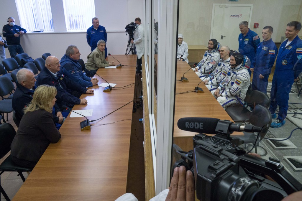 Expedition 63 crewmembers Chris Cassidy of NASA, Anatoly Ivanishin and Ivan Vagner of Roscosmos, talk to Roscosmos Director General Dmitry Rogozin, NASA Director for Human Space Flight Programs, Russia, Tricia Mack, left, and other mission managers prior to departing for the launch pad as backup crew members, Thursday, April 9, 2020 at the Baikonur Cosmodrome in Kazakhstan. A few hours later, they lifted off on a Soyuz rocket for a six-and-a-half month mission on the International Space Station.