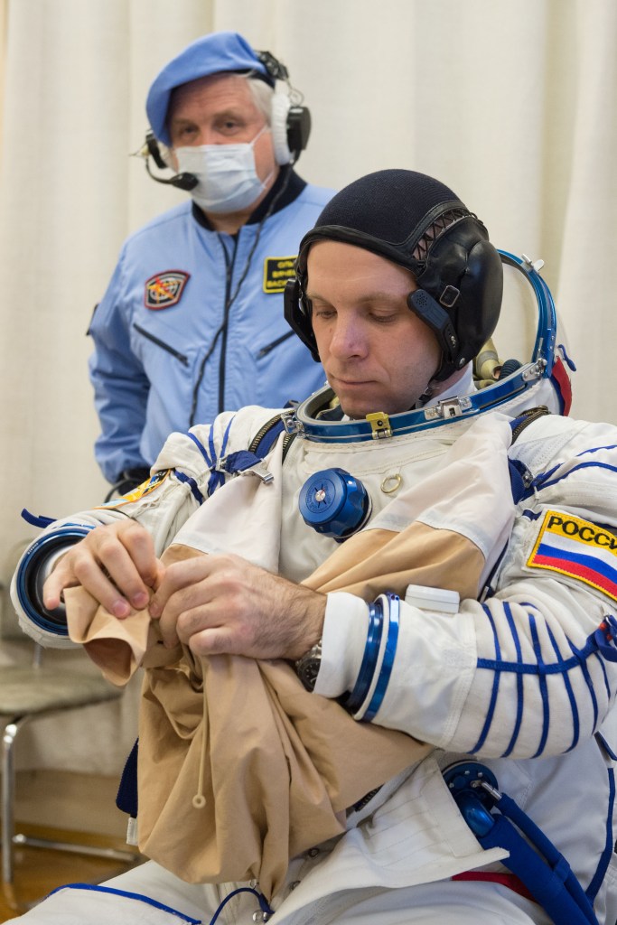 Expedition 63 crewmember Ivan Vagner of Roscosmos dons his Sokol suit a few hours ahead of his launch on a Soyuz rocket with Anatoly Ivanishin of Roscosmos, and Chris Cassidy of NASA, Thursday, April 9, 2020 at the Baikonur Cosmodrome in Kazakhstan. A few hours later, they lifted off for a six-and-a-half month mission on the International Space Station.