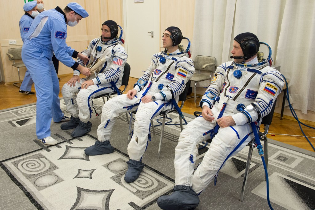 Expedition 63 crewmembers Chris Cassidy of NASA, left, Anatoly Ivanishin of Roscosmos, center, and Ivan Vagner of Roscosmos don their Sokol suits a few hours ahead of their launch on a Soyuz rocket, Thursday, April 9, 2020 at the Baikonur Cosmodrome in Kazakhstan. A few hours later, they lifted off for a six-and-a-half month mission on the International Space Station.