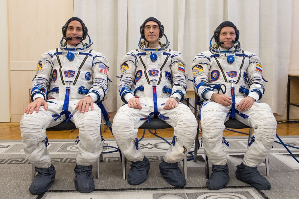 Expedition 63 crewmember Chris Cassidy of NASA, left, Anatoly Ivanishin of Roscosmos, center, and Ivan Vagner of Roscosmos pose for a group photo after suiting up and preparing for leak checks of their launch and entry suits at the Baikonur Cosmodrome in Kazakhstan as they prepared for launch Thursday, April 9, 2020 on the Soyuz MS-16 spacecraft. A few hours later, they lifted off for a six-and-a-half month mission on the International Space Station.