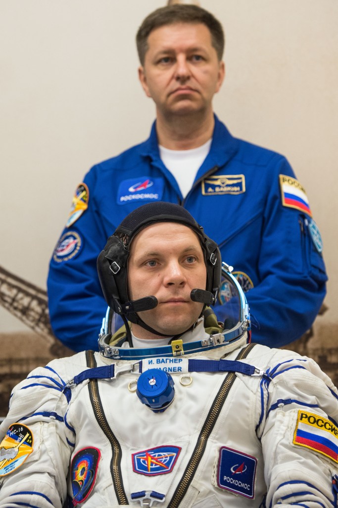 Expedition 63 crewmember Ivan Vagner of Roscosmos, foreground, waits to have his Sokol suit pressure checked, as backup crew member Andrei Babkin of Roscosmos looks on, Thursday, April 9, 2020 at the Baikonur Cosmodrome in Kazakhstan. A few hours later, Vagner, Anatoly Ivanishin of Roscosmos, and Chris Cassidy of NASA lifted off for a six-and-a-half month mission on the International Space Station.
