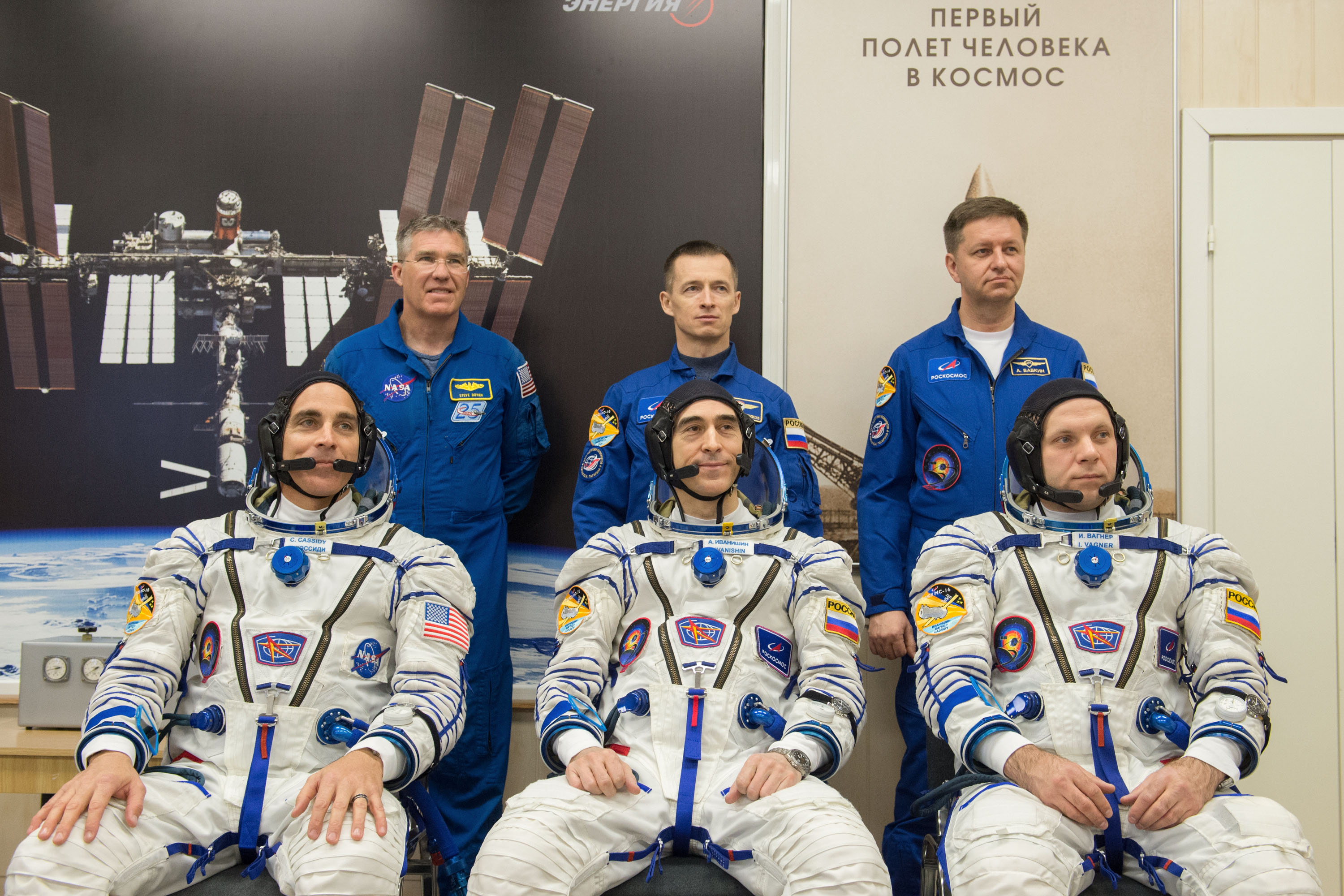 Expedition 63 crewmembers Chris Cassidy of NASA, seated left, Anatoly Ivanishin and Ivan Vagner of Roscosmos, seated right, pose for a photo with backup crew members Steve Bowen of NASA, standing left, Sergey Ryzhikov and Andrei Babkin and of Roscosmos , standing right after the crew had their Sokol suits pressure checked prior to launch on a Soyuz rocket, Thursday, April 9, 2020 at the Baikonur Cosmodrome in Kazakhstan. A few hours later, they lifted off for a six-and-a-half month mission on the International Space Station.