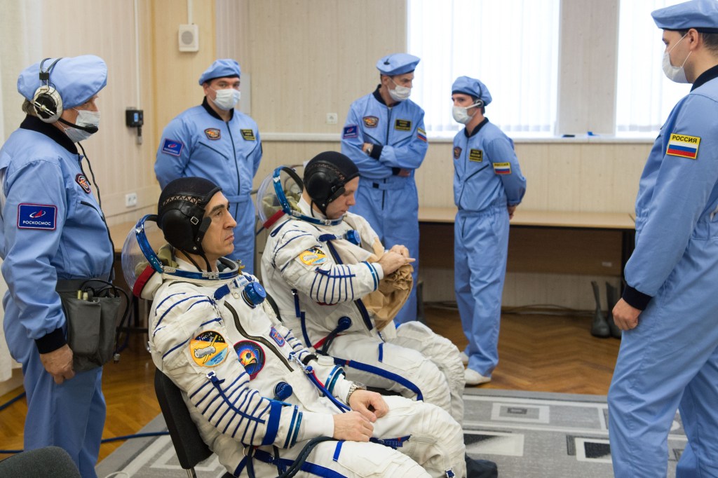 Expedition 63 crewmembers Anatoly Ivanishin, left, and Ivan Vagner of Roscosmos don their Sokol suits a few hours ahead of their launch on a Soyuz rocket with Chris Cassidy of NASA, Thursday, April 9, 2020 at the Baikonur Cosmodrome in Kazakhstan. A few hours later, they lifted off for a six-and-a-half month mission on the International Space Station.