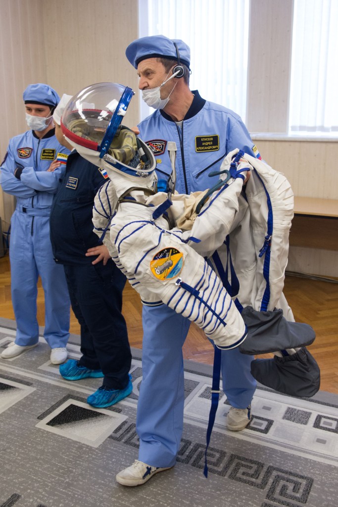 A technician prepares to help Expedition 63 crewmember Chris Cassidy of NASA don his Sokol Suit a few hours ahead of his launch on a Soyuz rocket with Ivan Vagner and Anatoly Ivanishin of Roscosmos, Thursday, April 9, 2020 at the Baikonur Cosmodrome in Kazakhstan. A few hours later, they lifted off for a six-and-a-half month mission on the International Space Station.