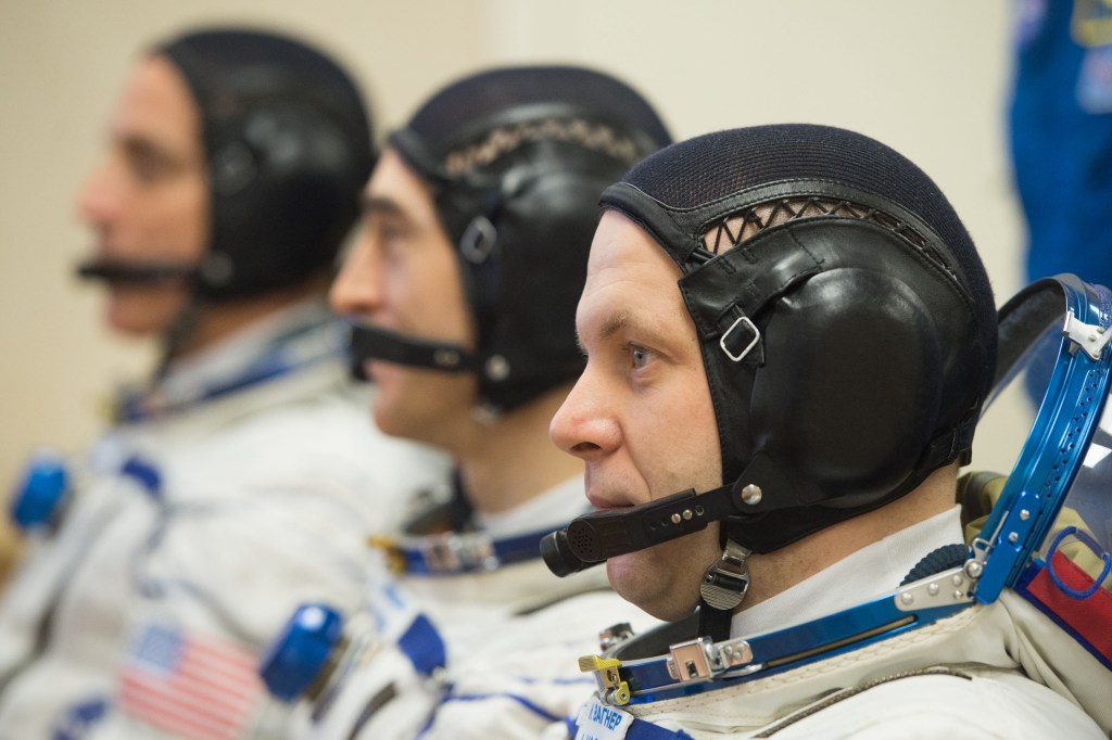 Expedition 63 crewmembers Chris Cassidy of NASA, left, Anatoly Ivanishin and Ivan Vagner of Roscosmos, right, talk to mission managers prior to departing for the launch pad, Thursday, April 9, 2020 at the Baikonur Cosmodrome in Kazakhstan. A few hours later, they lifted off on a Soyuz rocket for a six-and-a-half month mission on the International Space Station.