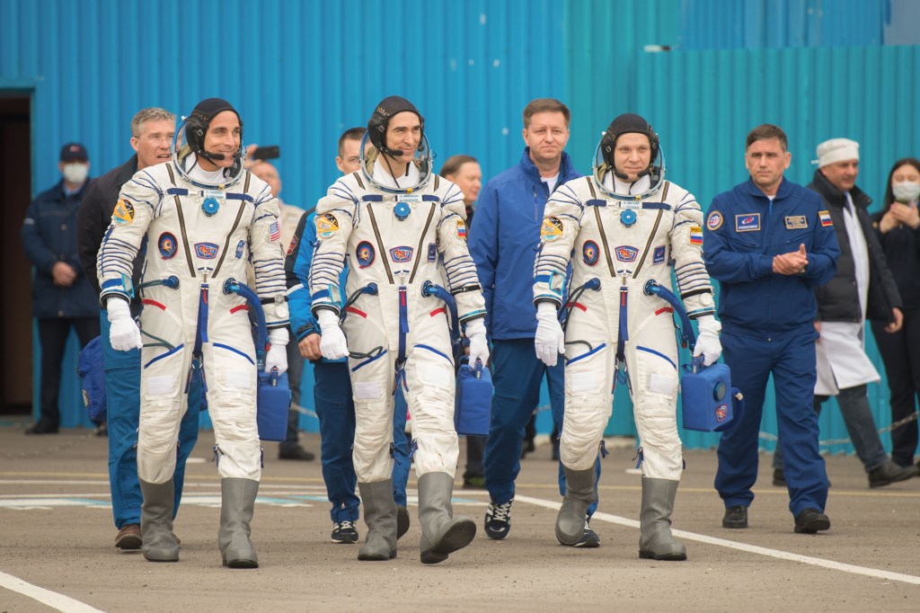 Expedition 63 crewmembers Chris Cassidy of NASA, left, Anatoly Ivanishin, center, and Ivan Vagner of Roscosmos, depart building 254 for the launch pad, Thursday, April 9, 2020 at the Baikonur Cosmodrome in Kazakhstan. A few hours later, they lifted off on a Soyuz rocket for a six-and-a-half month mission on the International Space Station.