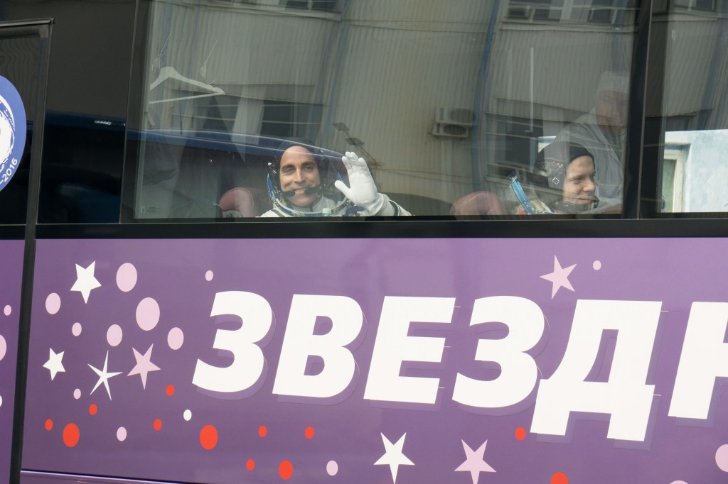 Expedition 63 crewmembers Chris Cassidy of NASA, left, Ivan Vagner and Anatoly Ivanishin of Roscosmos wave farewell as they depart for the launch pad, Thursday, April 9, 2020 at the Baikonur Cosmodrome in Kazakhstan. A few hours later, they lifted off on a Soyuz rocket for a six-and-a-half month mission on the International Space Station.