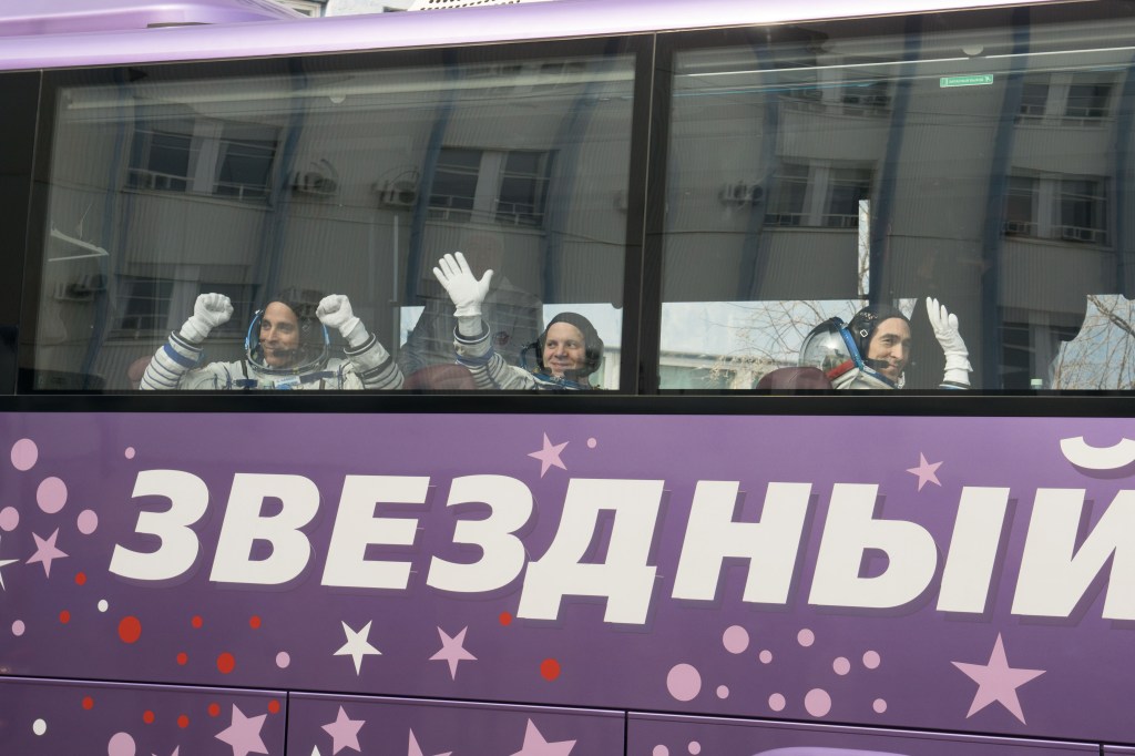 Expedition 63 crewmember Chris Cassidy of NASA, left, waves farewell as he, Anatoly Ivanishin and Ivan Vagner of Roscosmos depart for the launch pad, Thursday, April 9, 2020 at the Baikonur Cosmodrome in Kazakhstan. A few hours later, they lifted off on a Soyuz rocket for a six-and-a-half month mission on the International Space Station.