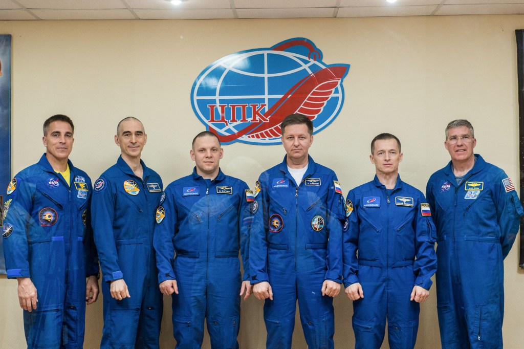 At the Cosmonaut Hotel crew quarters in Baikonur, Kazakhstan, the Expedition 63 prime and backup crewmembers pose for pictures April 8 as they prepare for launch. From left to right are prime crewmembers Chris Cassidy of NASA and Anatoly Ivanishin and Ivan Vagner of Roscosmos and backup crewmembers Andrei Babkin and Sergey Ryzhikov of Roscosmos and Steve Bowen of NASA. Cassidy, Ivanishin and Vagner will launch April 9 on the Soyuz MS-16 spacecraft from the Baikonur Cosmodrome for a six-and-a-half month mission on the International Space Station.