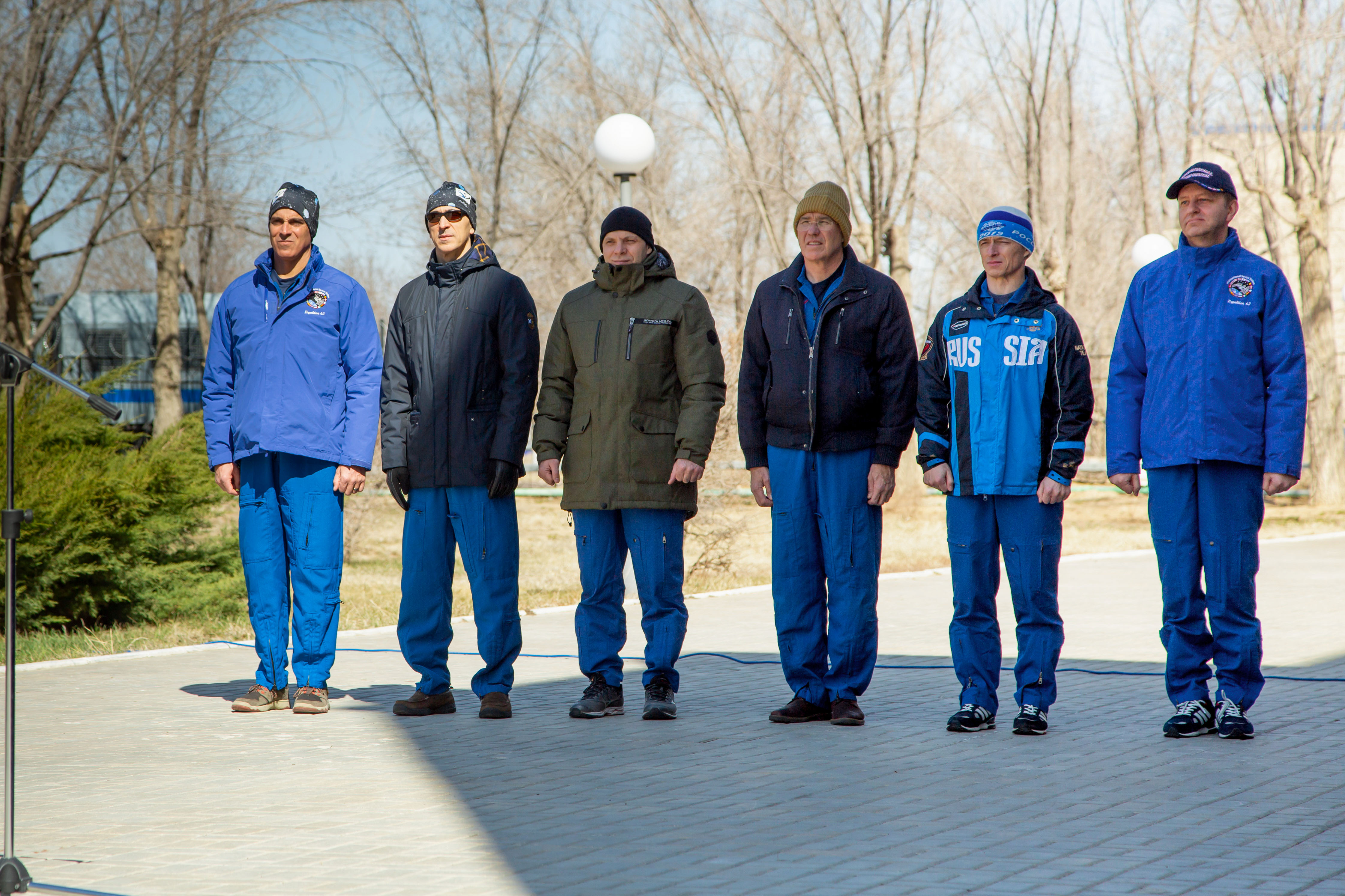 At the Cosmonaut Hotel crew quarters in Baikonur, Kazakhstan, the Expedition 63 prime and backup crews attend the traditional flag raising ceremony March 26 as part of their pre-launch activities. Seen from left to right are prime crewmembers Chris Cassidy of NASA, Anatoly Ivanishin and Ivan Vagner of Roscosmos and the backup crewmembers, Steve Bowen of NASA and Sergey Ryzhikov and Andrei Babkin of Roscosmos. Cassidy, Ivanishin and Vagner will launch April 9 from the Baikonur Cosmodrome on the Soyuz MS-16 spacecraft for a six-and-a-half month mission on the International Space Station.