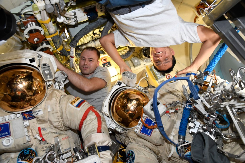 iss068e054772 (Nov. 16, 2022) --- Expedition 68 Flight Engineers (from left) Dmitri Petelin of Roscosmos and Frank Rubio of NASA work on Orlan spacesuit maintenance inside the International Space Station's Poisk module.