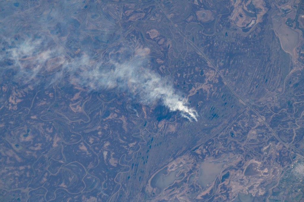 Victoria, Argentina (lower right), pictured from the International Space Station, is located on the eastern edge of the Parana River floodplain. Smoke like this is typical of Argentina and comes from either natural or man-made fires.