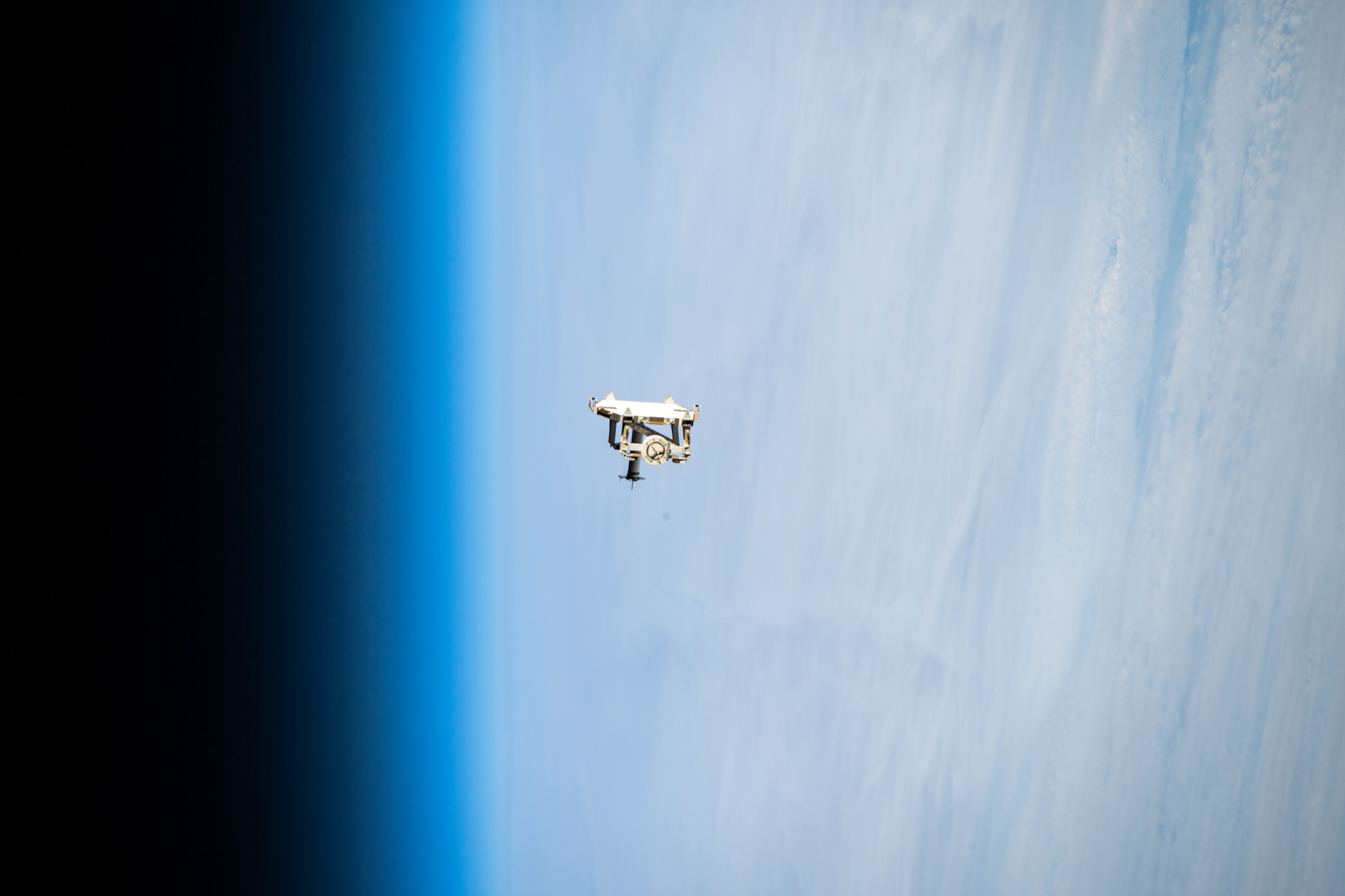 iss068e044261 (Jan. 31, 2023) --- Flight support equipment is pictured descending toward the Earth's atmosphere after being jettisoned from the grips of the Canadarm2 robotic arm. The flight hardware secured a pair of roll-out solar arrays inside SpaceX Dragon cargo ship’s trunk during its ascent to orbit and rendezvous with the International Space Station in November 2022. The jettisoned support equipment drifted safely away from the station and will eventually harmlessly burn up in the atmosphere with no chance for recontacting the space station.