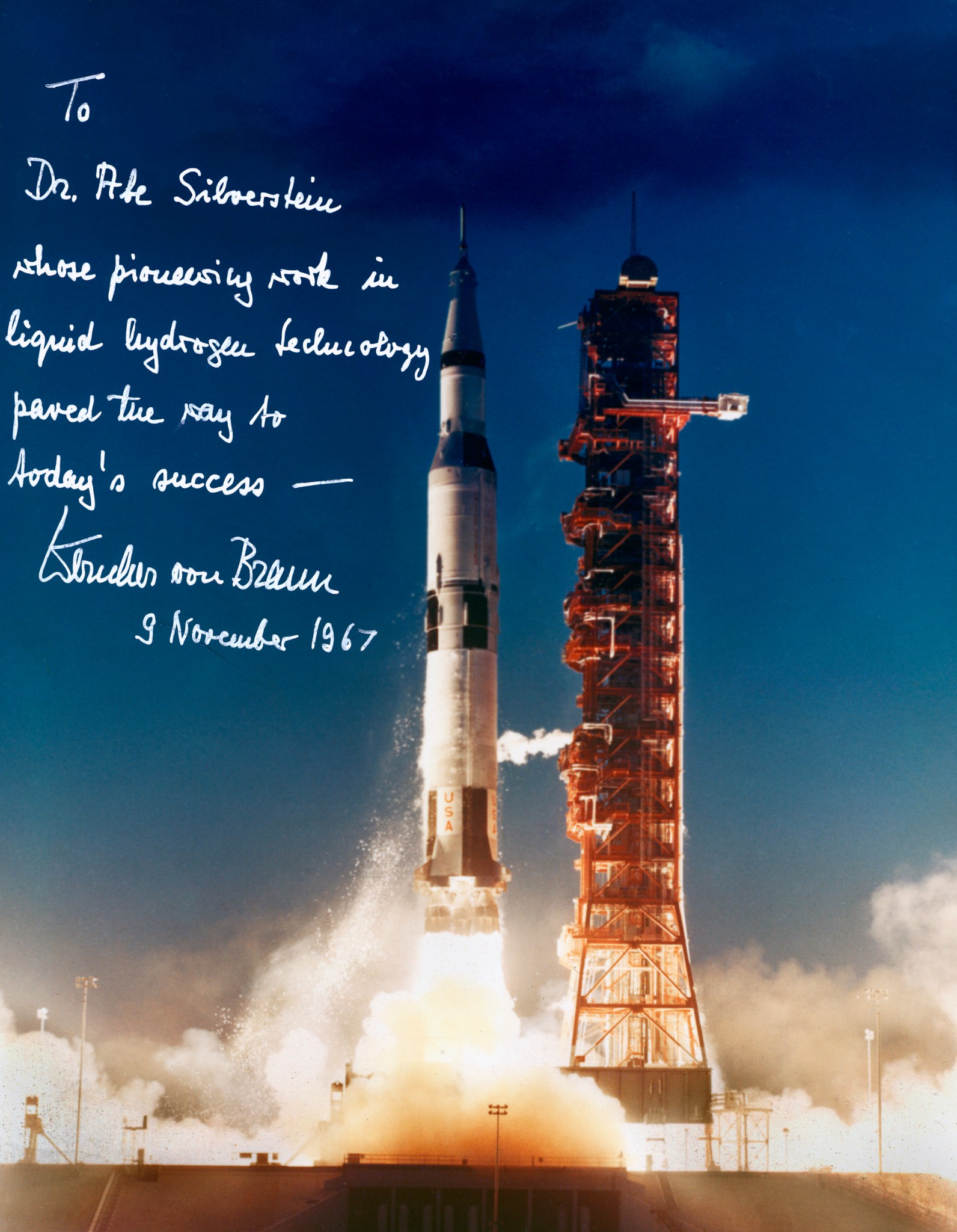 Photograph of Saturn V launch with note written on it.
